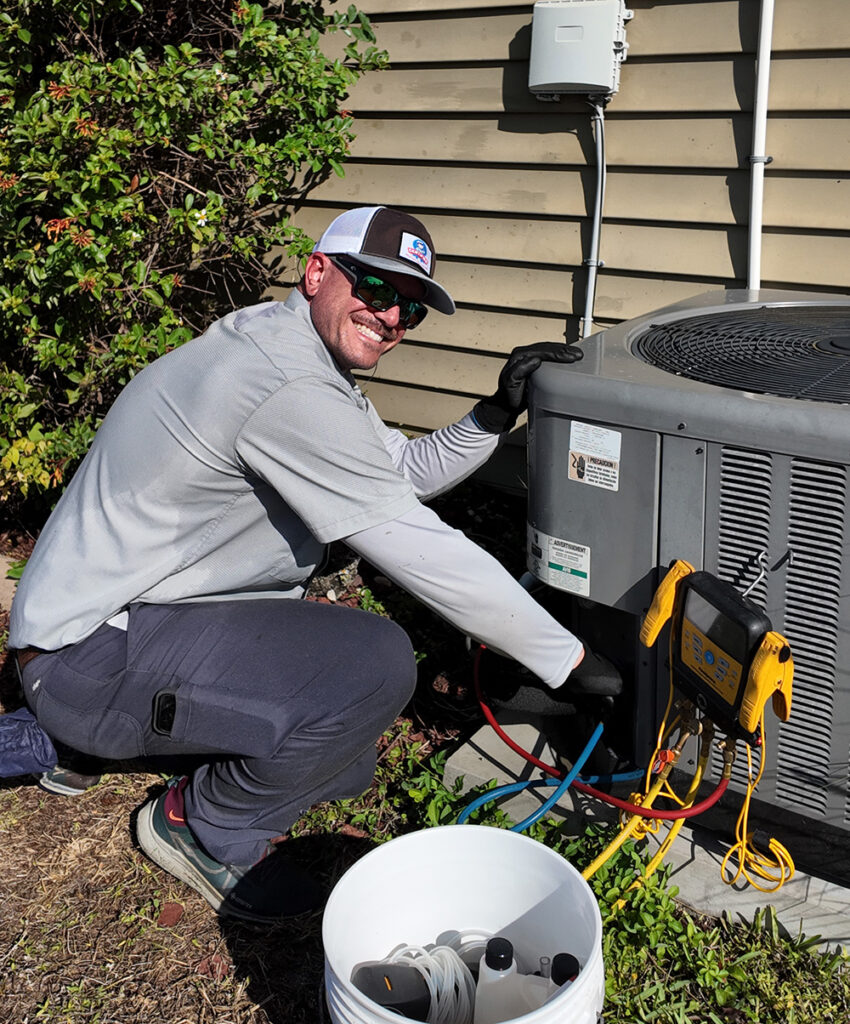 certified technician performing ac maintenance outside of a customers home