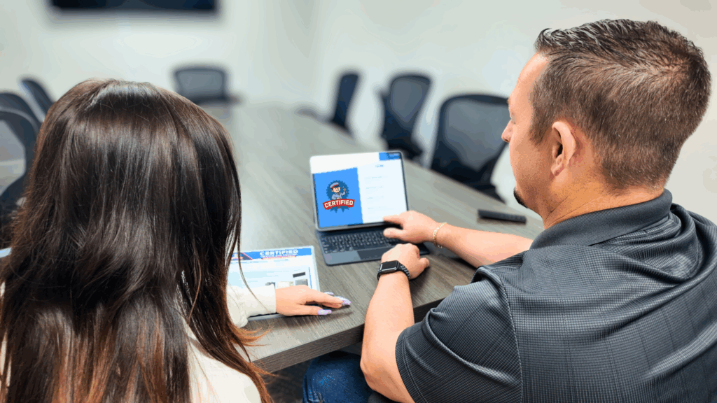 a certified customer service representative sitting inside a conference room with a customer, going over financing options