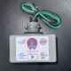 A gray surge protector for Southwest Florida homes sits on a dark surface, showing green, black, white wires, labels, and a UL mark.